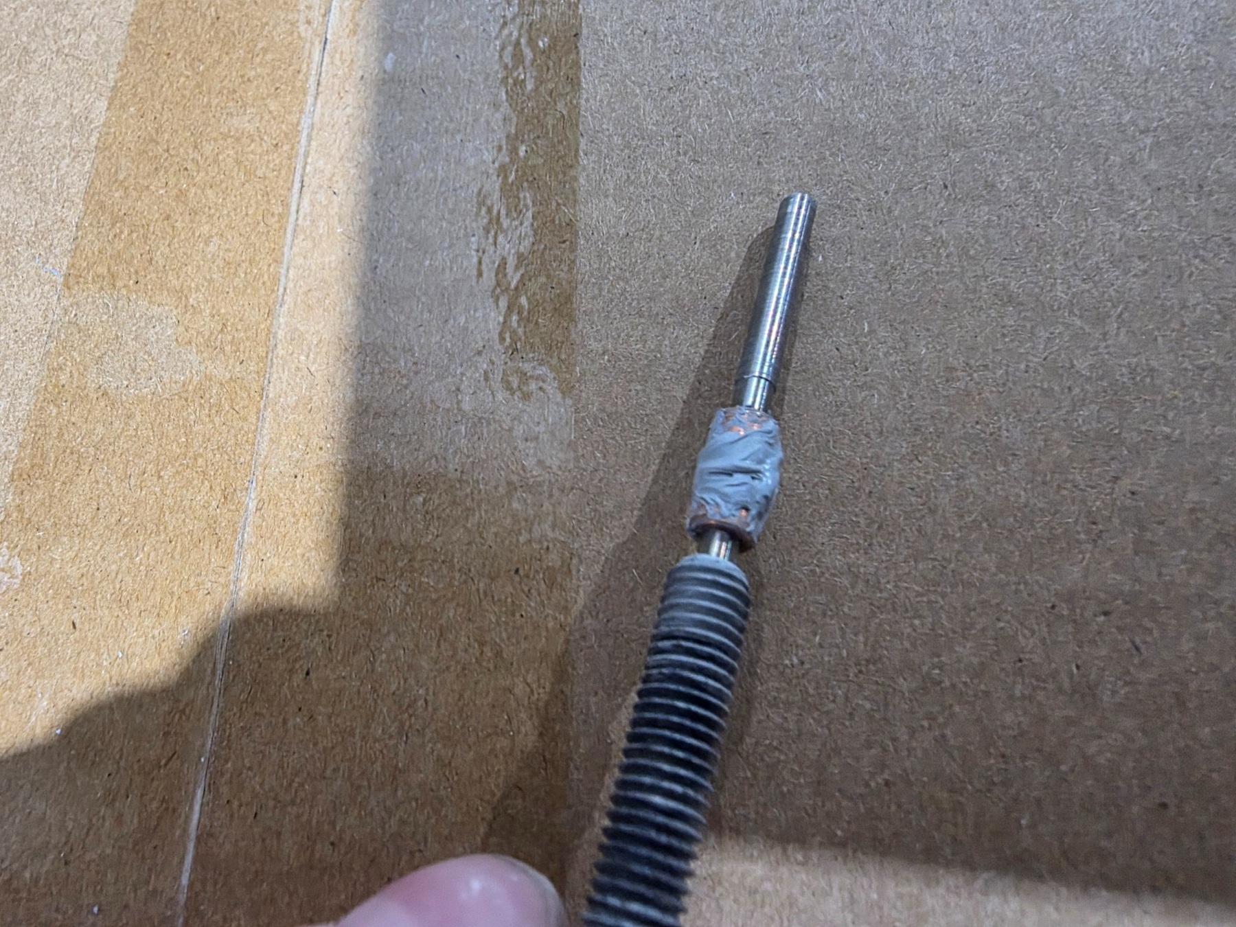 Applying fresh thermal interface material to a Creality K2 Plus hotend component during service.